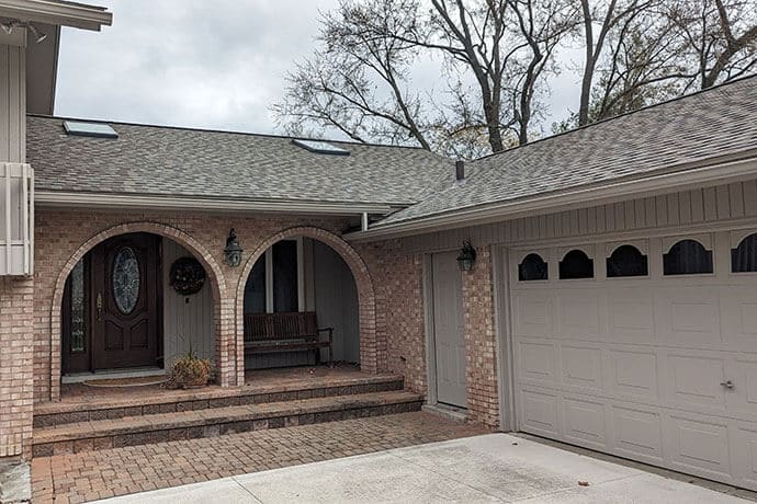 Ground view of home with new roof