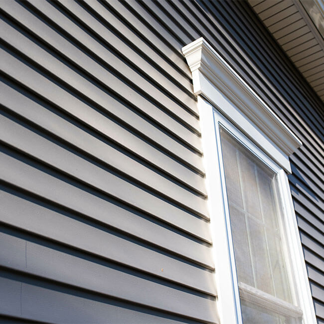 Dark vinyl siding in residential neighborhood, new window treatments