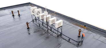 Outdoor air conditioning units on roof. Air conditioning system opens onto roof. Concept - air purification system in building. Flat roof of building top view. Sale oxygen purification equipment.