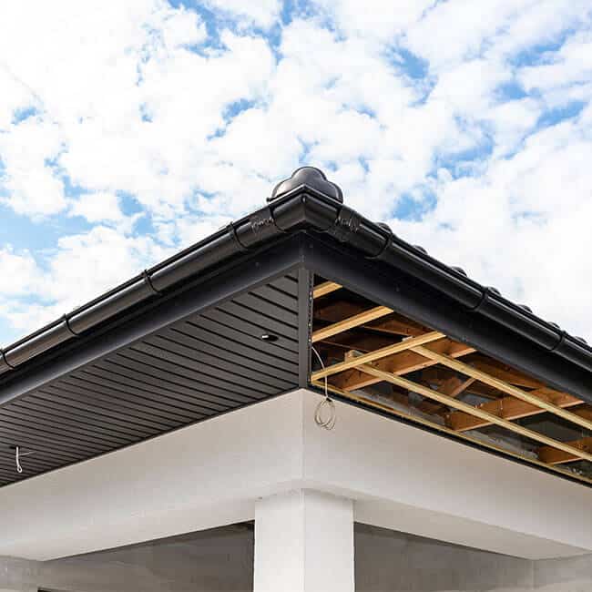 Scaffolding with three rows of wooden battens and a modern graphite soffit made in half, visible H and J slats.