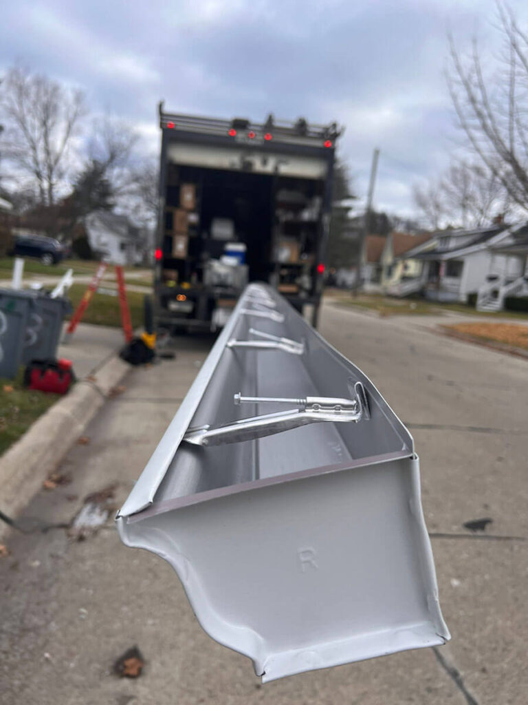 Long shot of a new gutter coming out of a truck