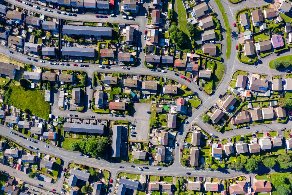 An aerial drone view of multiple neighborhood streets in a small town.