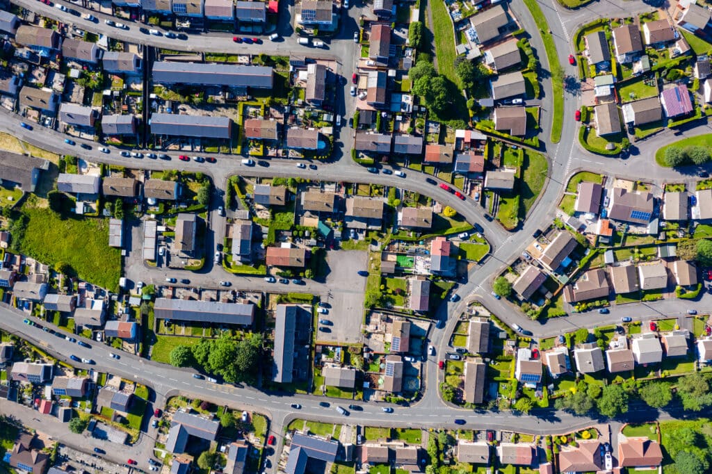 An aerial drone view of multiple neighborhood streets in a small town. 