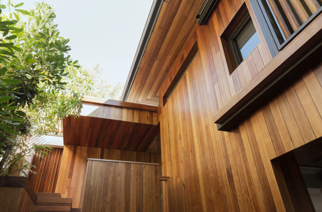 A close-up of the back of a home that has vertical wood siding.