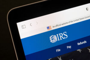 Part of a tablet. On the tablet's screen is the IRS website.