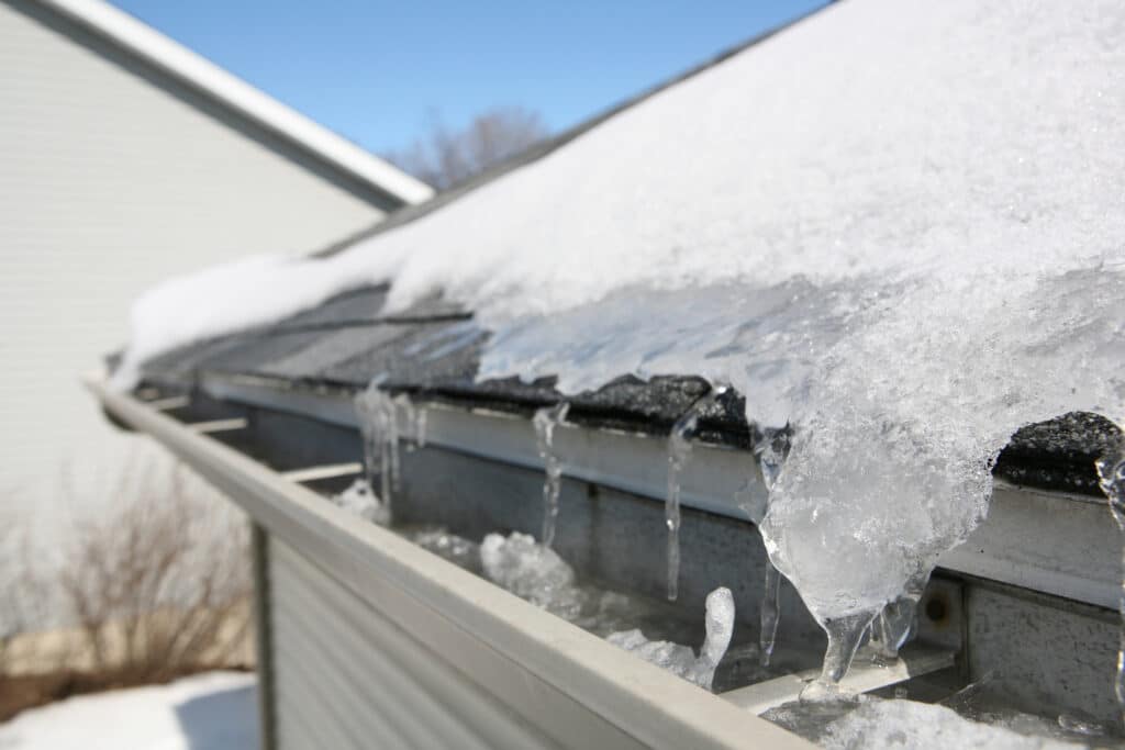 Build up of snow and ice on a roof and gutters