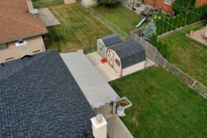 Birds eye view of house and shed with new roof
