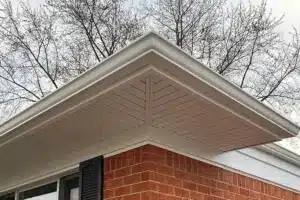 Corner of a home with new white, seamless gutters