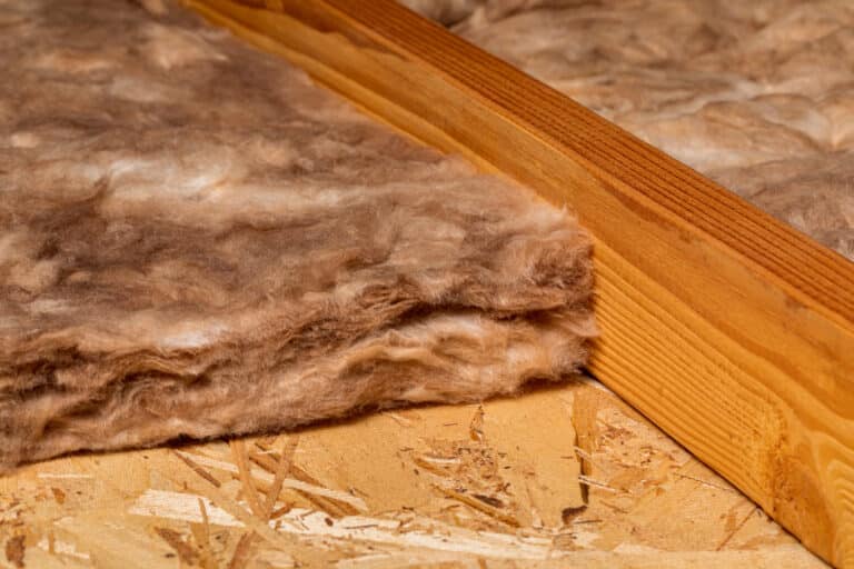 Fiberglass insulation next to an attic baffle