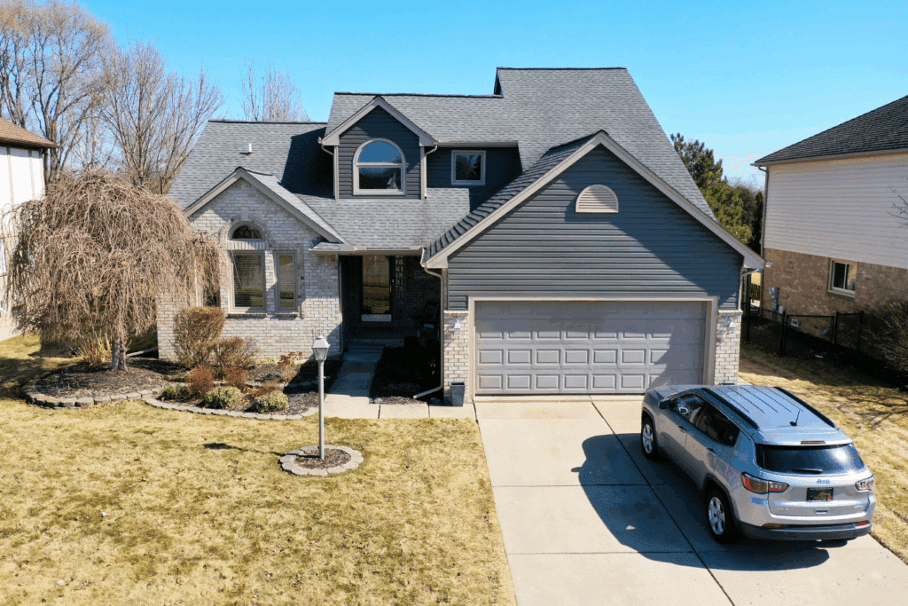 A front view of a home with a new roof and siding