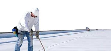 Worker applies an insulation coating on the concrete surface of a rooftop. Repairman fixing a leaking roof or deck by applying waterproofing solution