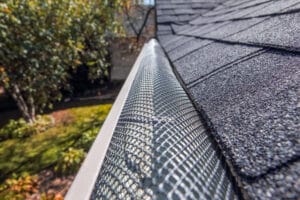 A plastic mesh guard installed on gutters