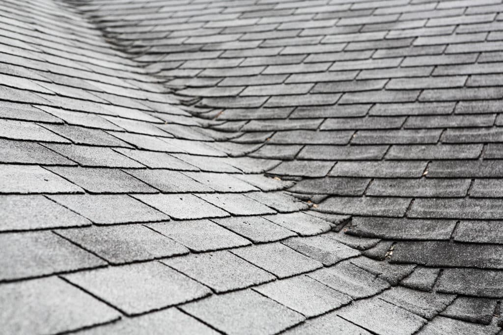 Curling shingles on an old composite roof