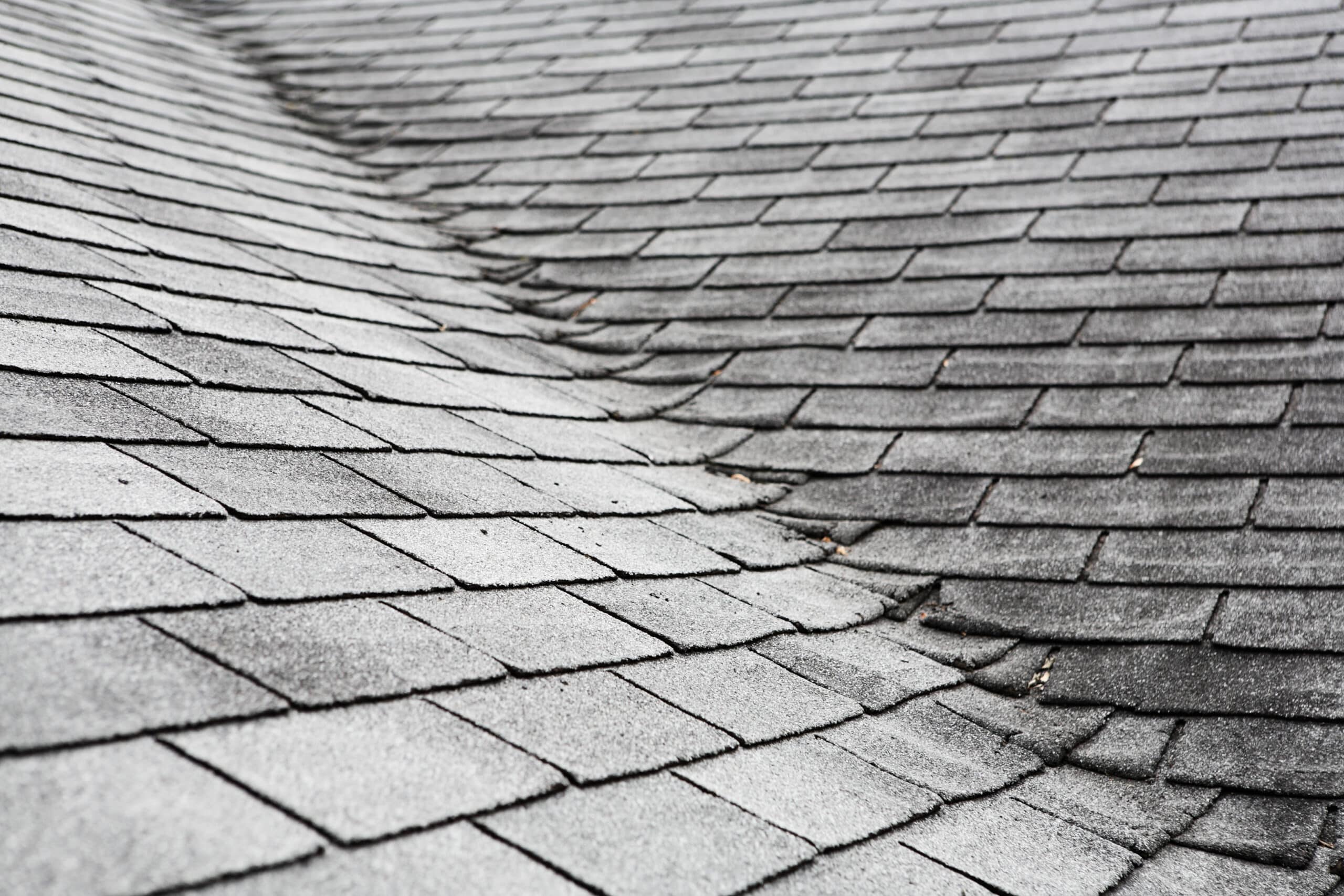 Curling shingles on an old composite roof