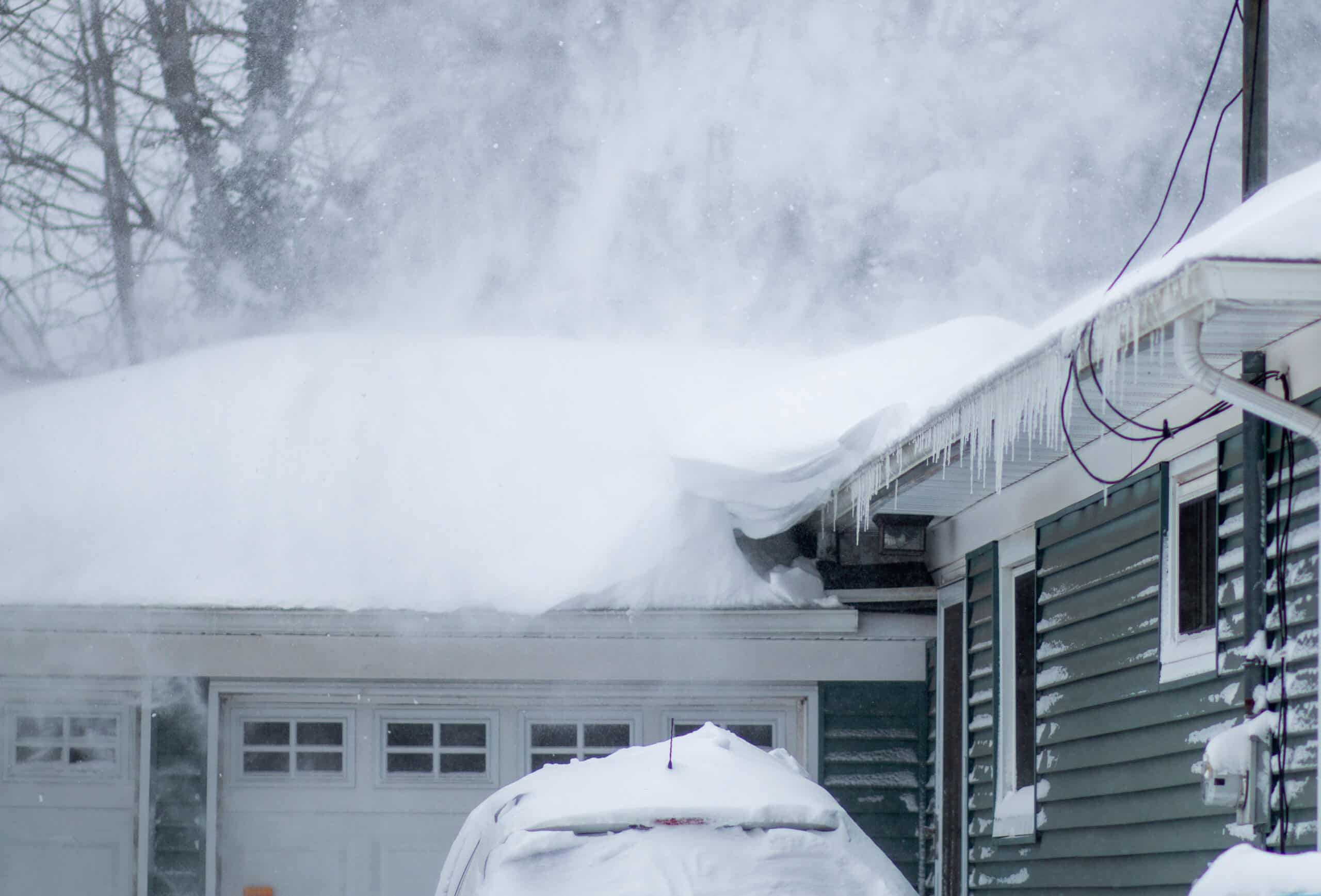 Snow blowing off a residential roof