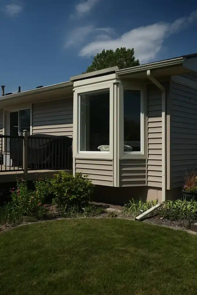 The back of a home with a bay window and new siding